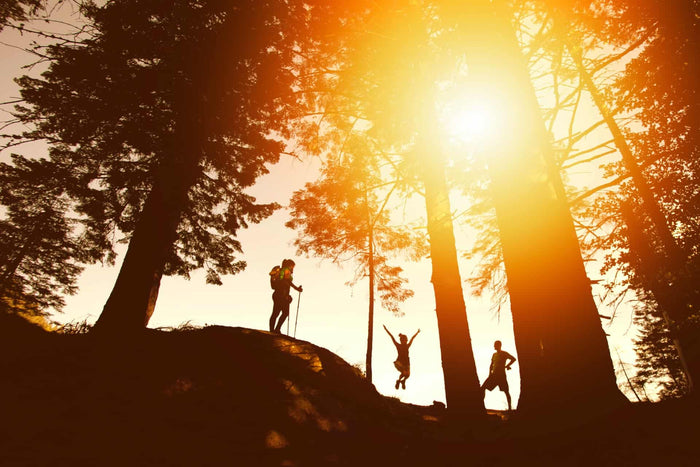 Three hikers wearing toe socks at sunset